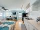 Sunlit kitchen features white cabinetry, stainless steel appliances, and tiled backsplash, adjacent to a dining area at 308 2Nd St N # 202, Bradenton Beach, FL 34217