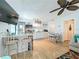 Bright open kitchen features white cabinetry, stainless steel appliances, and dining space at 308 2Nd St N # 202, Bradenton Beach, FL 34217