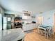 Bright kitchen boasts stainless steel appliances, white cabinetry, and a cozy dining nook at 308 2Nd St N # 202, Bradenton Beach, FL 34217