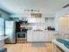 Well-lit kitchen featuring white cabinets, subway tile backsplash, and stainless steel appliances at 308 2Nd St N # 202, Bradenton Beach, FL 34217