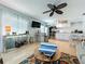 Open-concept living area with tiled floors, modern furniture, and a seamless transition to the well-equipped kitchen at 308 2Nd St N # 202, Bradenton Beach, FL 34217