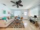 Cozy living room features a comfortable sofa, vibrant rug, and decorative touches, flooded with natural light at 308 2Nd St N # 202, Bradenton Beach, FL 34217
