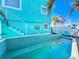 Outdoor pool area with vibrant blue accents and stairs to an upper level, blending leisure with coastal design at 308 2Nd St N # 202, Bradenton Beach, FL 34217