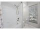 Bathroom with shower and tub combination, tile floor, and window for ample lighting at 5501 E Longboat Blvd, Tampa, FL 33615