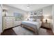 Comfortable bedroom with a ceiling fan and dresser near a bright window at 5501 E Longboat Blvd, Tampa, FL 33615