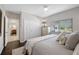 Inviting bedroom featuring a ceiling fan, natural light, and convenient access to the ensuite bathroom at 5501 E Longboat Blvd, Tampa, FL 33615