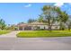 Lovely single-story home boasts a three-car garage and well-manicured lawn and landscaping at 5501 E Longboat Blvd, Tampa, FL 33615
