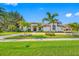 Beautiful single-story home featuring lush landscaping, a circular driveway, and a tile roof at 5501 E Longboat Blvd, Tampa, FL 33615