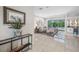 Bright living room with tile floors and sliding glass doors to the pool area and a built-in bar for entertaining at 5501 E Longboat Blvd, Tampa, FL 33615