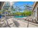 Screened-in pool area with lounge chairs and mature landscaping creating backyard privacy at 5501 E Longboat Blvd, Tampa, FL 33615