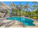 Inviting screened-in pool area with lush landscaping offering a private backyard oasis at 5501 E Longboat Blvd, Tampa, FL 33615