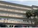 Multi-story condo building featuring balconies with decorative privacy screens and mature palm trees at 5603 80Th N St # 512, St Petersburg, FL 33709