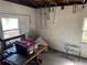 An unfinished basement offers ample storage with exposed ceiling and walls, along with scattered belongings at 8075 Gulf Blvd, St Pete Beach, FL 33706