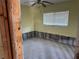 Bedroom awaiting renovation, featuring a window and ceiling fan at 8075 Gulf Blvd, St Pete Beach, FL 33706