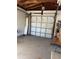This is an image of a garage with a white door and block walls, showcasing an ample storage or parking space at 8075 Gulf Blvd, St Pete Beach, FL 33706