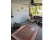 Enclosed sunroom with outdoor furniture, rug, and decor, perfect for relaxation at 8075 Gulf Blvd, St Pete Beach, FL 33706