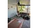 Enclosed sunroom with outdoor furniture, rug, and decor, perfect for relaxation at 8075 Gulf Blvd, St Pete Beach, FL 33706