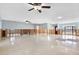 Spacious room with tile flooring, ceiling fans, and natural light ready for renovation at 8421 Flagstone Dr, Tampa, FL 33615