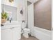 Modern bathroom with a sleek vanity, neutral tiling, and a shower-tub combination at 881 6Th S Ave, St Petersburg, FL 33701