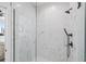 Modern shower featuring marble-look tile, glass enclosure, and matte black hardware at 881 6Th S Ave, St Petersburg, FL 33701
