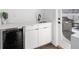 A stylish wet bar features white cabinets, a stainless steel sink, and a beverage refrigerator at 881 6Th S Ave, St Petersburg, FL 33701