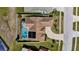 Aerial view of a home with pool, driveway, landscaping and solar panels at 9229 Water Hazard Dr, Hudson, FL 34667