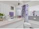Bright bathroom featuring a single vanity, tub/shower combo, and white finishes at 9229 Water Hazard Dr, Hudson, FL 34667