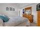 Comfortable bedroom featuring soft lighting, a full-size bed, and wood furniture at 9229 Water Hazard Dr, Hudson, FL 34667