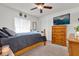 Well-lit bedroom featuring a full-size bed, wood furniture, and a large window at 9229 Water Hazard Dr, Hudson, FL 34667