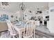 Elegant dining room with seating for six, adjacent to an open-concept kitchen and living area at 9229 Water Hazard Dr, Hudson, FL 34667