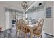 Bright dining room with natural wood table and seating for six, adjacent to sliding glass doors at 9229 Water Hazard Dr, Hudson, FL 34667