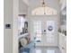 Bright and inviting entryway features a tiled floor, arched window, and a decorative bench for welcoming guests at 9229 Water Hazard Dr, Hudson, FL 34667