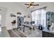 Well-lit home office with luxury vinyl flooring, a ceiling fan, and a large window overlooking the yard at 9229 Water Hazard Dr, Hudson, FL 34667
