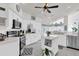 Modern white kitchen with stainless appliances, granite countertops, and a central island for cooking and entertaining at 9229 Water Hazard Dr, Hudson, FL 34667