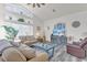 Spacious living room with vaulted ceilings, large windows, and comfortable seating at 9229 Water Hazard Dr, Hudson, FL 34667