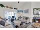 Bright living room with comfortable seating, decor, and sliding glass doors to the lanai at 9229 Water Hazard Dr, Hudson, FL 34667