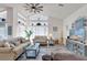Bright and open living room featuring vaulted ceilings, modern décor, and stylish furnishings at 9229 Water Hazard Dr, Hudson, FL 34667