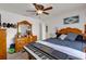 Comfortable bedroom with ceiling fan, beautiful dresser with a large mirror, and a comfortable bed at 9229 Water Hazard Dr, Hudson, FL 34667