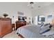 Comfortable main bedroom with neutral tones, wood furniture, and a view into the ensuite bathroom at 9229 Water Hazard Dr, Hudson, FL 34667