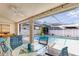 Covered patio with ceiling fan, bar and view of screened pool and backyard at 9229 Water Hazard Dr, Hudson, FL 34667