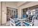 Covered patio featuring a glass table and seating for four at 9229 Water Hazard Dr, Hudson, FL 34667