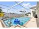 Beautiful backyard screened-in pool with clear water, a pool float, and ample space at 9229 Water Hazard Dr, Hudson, FL 34667