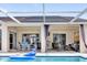 Enclosed patio with a pool, outdoor seating, and a comfortable lounge area for relaxing and entertaining at 9229 Water Hazard Dr, Hudson, FL 34667