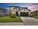 Charming two-story home featuring a well-manicured lawn and a two car garage with a neutral color scheme at 13526 Palmera Vista Dr, Riverview, FL 33579