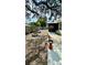 View of backyard featuring a fire pit, seating areas, and planting areas at 1670 Monterey Dr, Clearwater, FL 33756