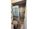 Tiled walk-in shower with safety bar and shower seat, in a remodeled bathroom at 1670 Monterey Dr, Clearwater, FL 33756
