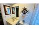 Bright bathroom featuring decoratively-framed mirrors, beach themed towel hangers, and a vanity at 1670 Monterey Dr, Clearwater, FL 33756