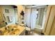 Neutral bathroom with a tub and shower combination, a single sink vanity and decorative elements at 1670 Monterey Dr, Clearwater, FL 33756