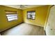 Bedroom with light-colored walls, wood-look floors, and natural light from two windows at 1670 Monterey Dr, Clearwater, FL 33756