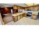 Charming kitchen with stainless steel appliances and wood cabinets open to adjacent living room at 1670 Monterey Dr, Clearwater, FL 33756